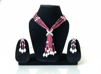 Jewelry set with pink and white beaded necklace and earrings