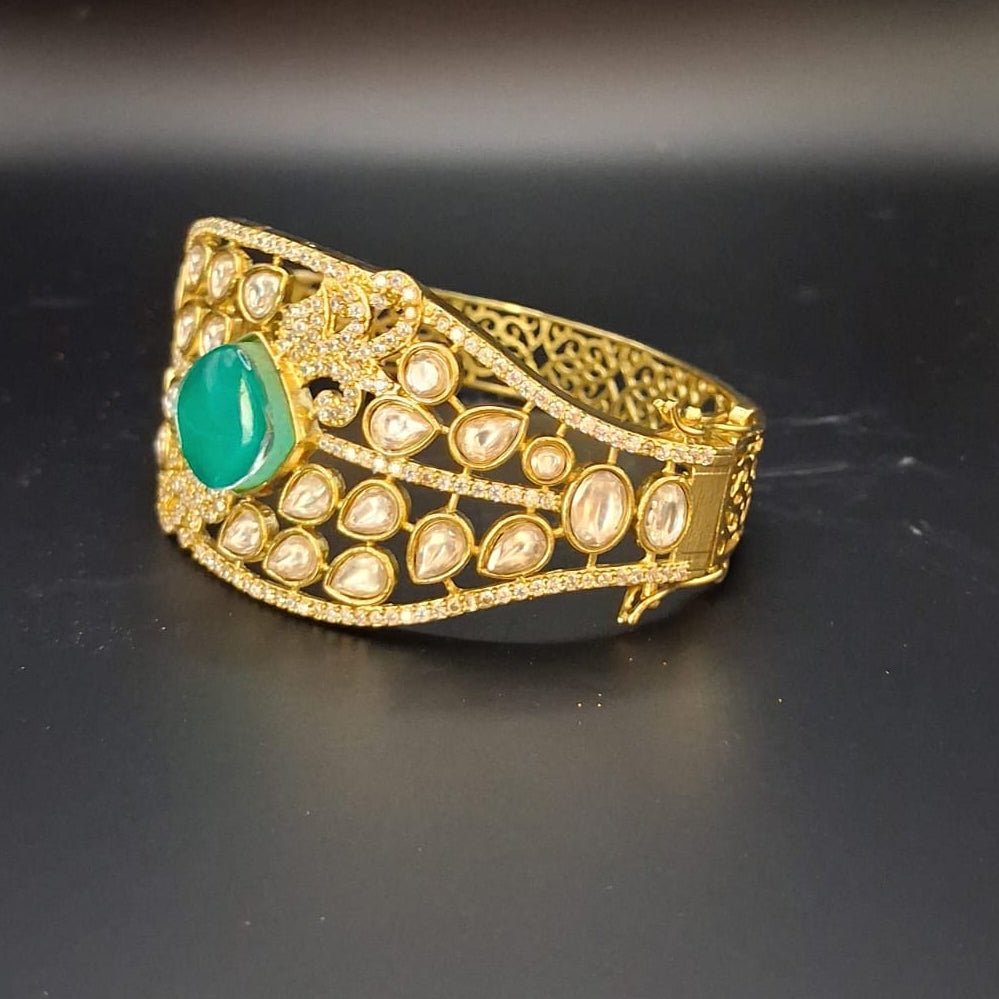 Gold bracelet with a green gemstone 