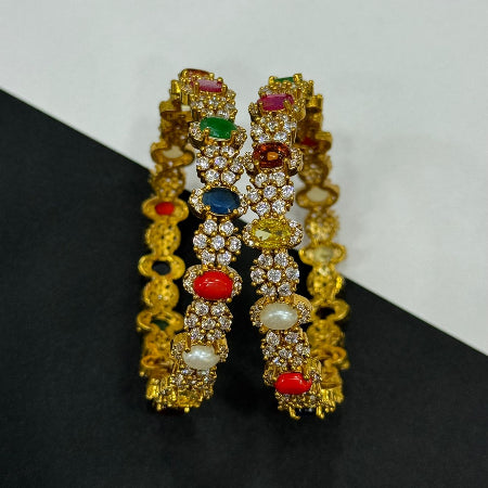 Pair of gold bangles with colorful gemstones 